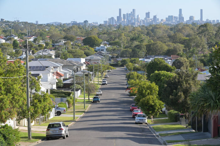 Brisbane - Nov 18 2023:Residential houses street against Brisbane City skyline.Home prices across Australia have hit new highs, with the median value of a home in a capital city shooting to $832,000.