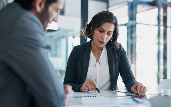 businesswoman looking over commercial property reports doing due diligence prior to purchase