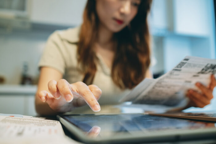 Woman calculating debt recycling pros and cons