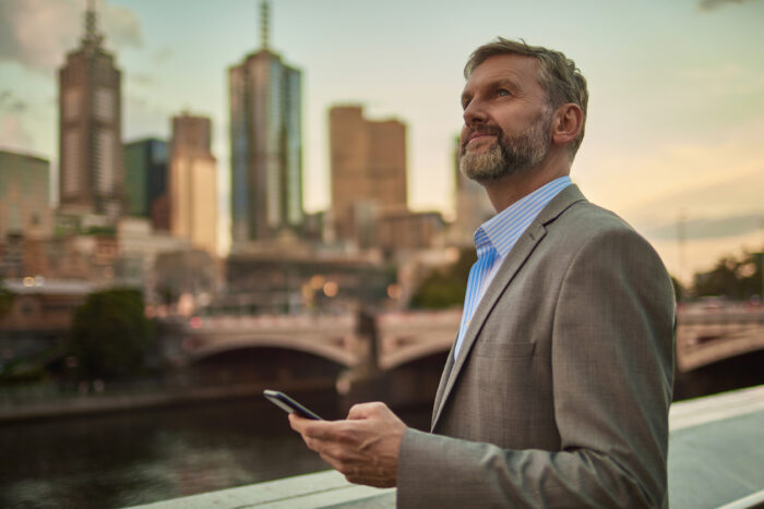 businessman contemplating due diligence in front of commercial properties in Australia