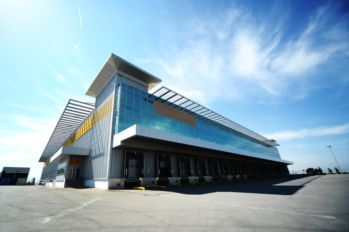 industrial warehouse investment with blue sky in background