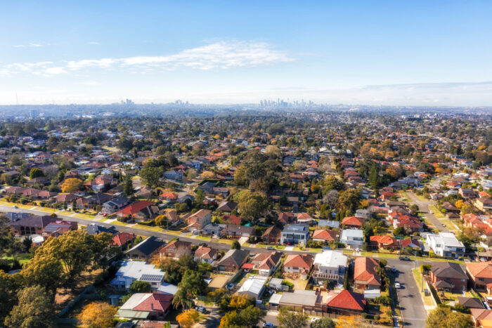 City of Ryde residential suburbs of Greater Sydney in Australia - aerial view towards distant city CBD on horizon.