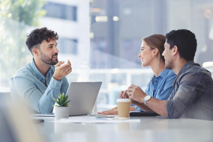 Investment professionals discussing rent vesting in boardroom. 