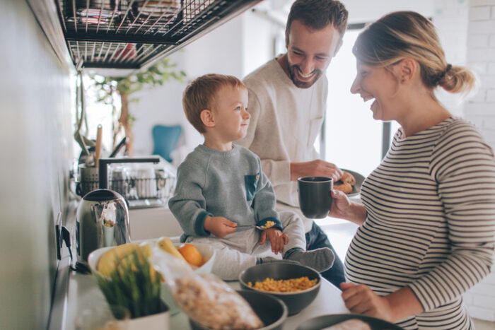 Young family having breakfast together in kitchen