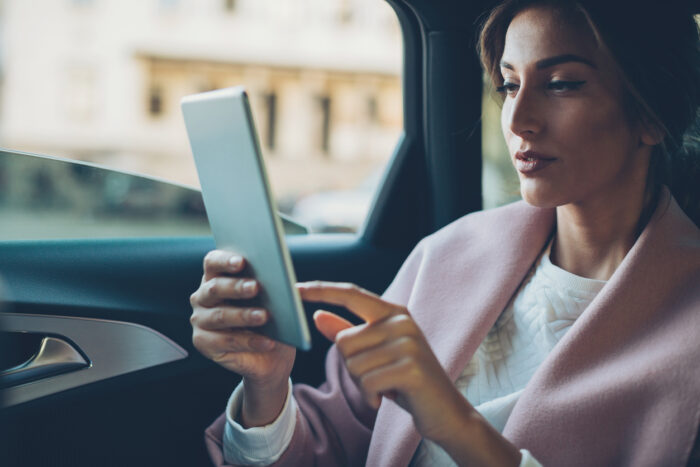 Wholesale investor looking at wholesale investment funds in back of a car