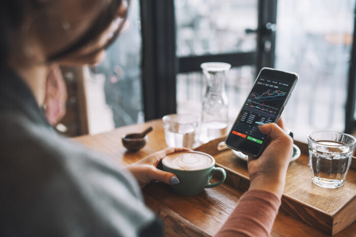 Unrecognisable woman using smartphone buy cryptocurrency at a coffee shop, blockchain investment, decentralize and Stock market concept.