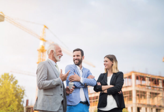 Happy business people on a construction site.