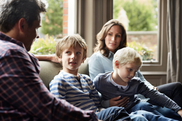 Young family of four on couch discussing best way to use an inheritance 