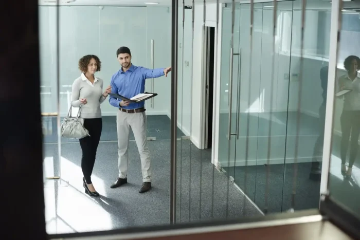 Commercial landlord discussing WALE with tenant inside office property. 