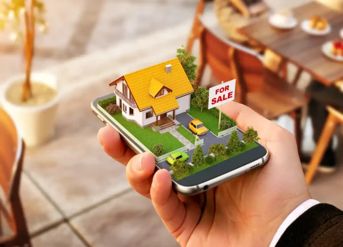 3D home appearing above a smartphone held in a man's hand.